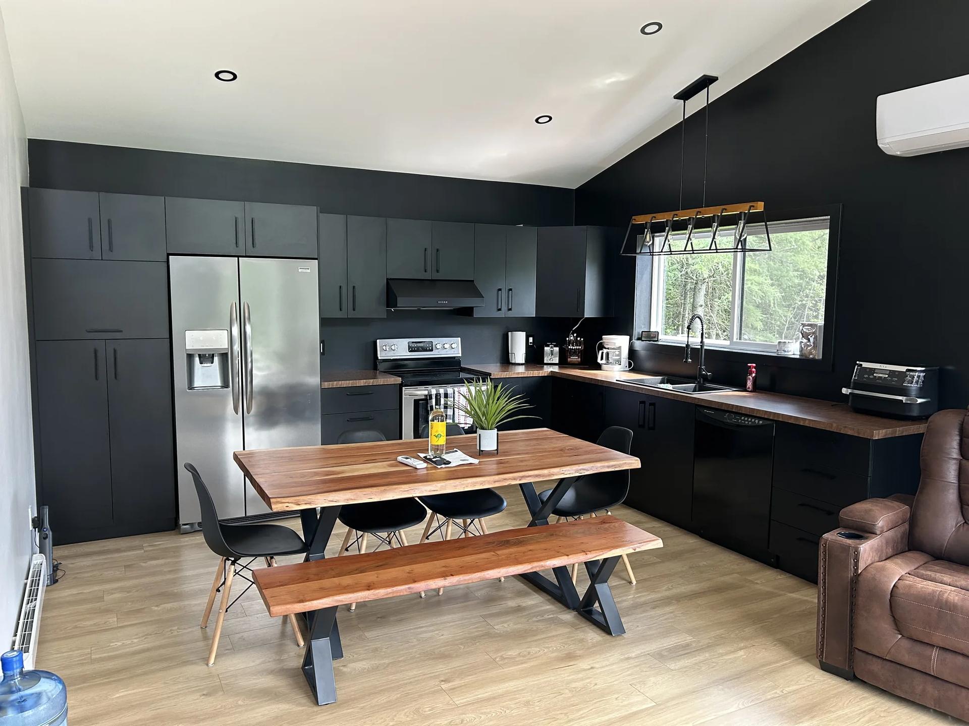Black contemporary kitchen, wood counter